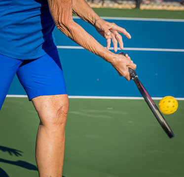 Close up of paddle and ball used in the game of pickleball