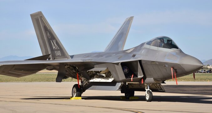 An Air Force F-22 Raptor fighter jet taxiing on a runway.