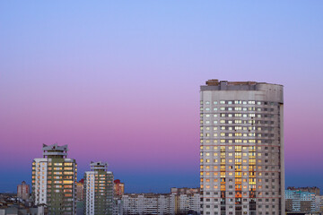 city skyscrapers in the evening with sunset light and colorful sky - city scape with copy space