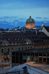View over the town of Bern to the Bundeshaus in the evening light against a mountain backdrop - Bern, Switzerland