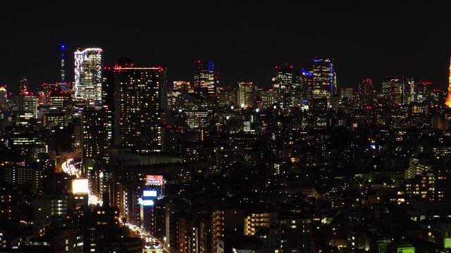 TOKYO, JAPAN : Aerial sunrise CITYSCAPE of TOKYO. View of dawn city and buildings at downtown area. Japanese urban city life and metropolis concept. Long time lapse tracking video, night to morning.