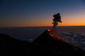 Sunset at Volcan Acatenango with view towards the Fire volcano erupting in Guatemala with the sky...