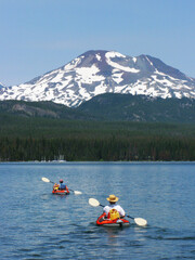 Kayaking on Elk Lake, Oregon - Two kayakers are enjoying the calm waters on Elk Lake, Oregon with Mt Bachelor in the background