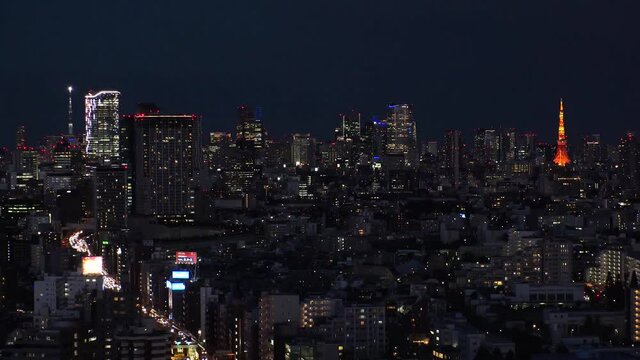 TOKYO, JAPAN : Aerial sunrise CITYSCAPE of TOKYO. View of dawn city and buildings at downtown area. Japanese urban city life and metropolis concept. Long time lapse zoom in video, night to morning.