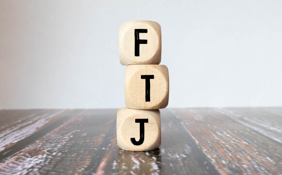 Cubes or dice with acronym PTJ for Part Time Job on wooden background