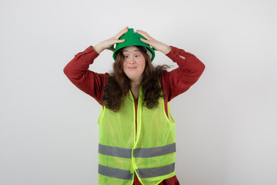 Image of a young cute girl standing in vest and wearing a crash helmet