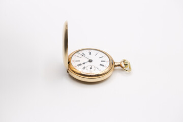 vintage golden pocket watch isolated on white background.