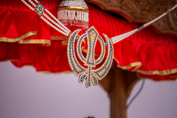 Indian Punjabi Sikh wedding ceremony ritual items, gurdwara decorations, hands close up