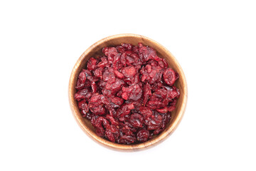 Top view of dried cranberries in wooden bowl isolated on white background