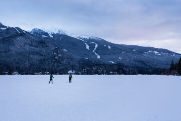 Cross country skier on frozen winter lake in Whistler, BC.