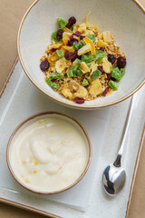 Plates with muesli and yogurt on the table. Oatmeal with fruit and yogurt. Healthy eating. Light and tasty breakfast. Diet
