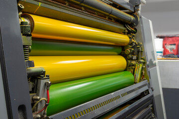 Color and glossy rollers of offset printing machine. offset ink colour. Yellow - obrazy, fototapety, plakaty