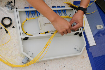 Technicians are cutting and fusion fiber optic cables.
