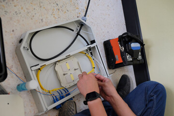 Technicians are cutting and fusion fiber optic cables.