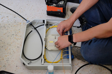 Technicians are cutting and fusion fiber optic cables.