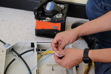 Technicians are cutting and fusion fiber optic cables.