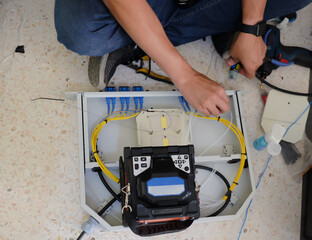 Technicians are cutting and fusion fiber optic cables.