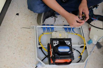 Technicians are cutting and fusion fiber optic cables.