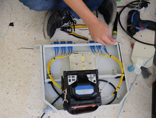 Technicians are cutting and fusion fiber optic cables.