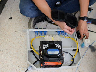 Technicians are cutting and fusion fiber optic cables.