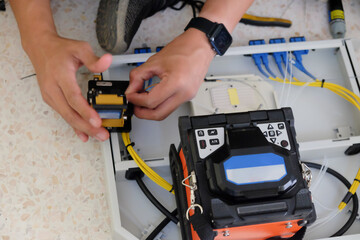 Technicians are cutting and fusion fiber optic cables.