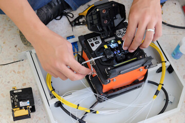 Technicians are cutting and fusion fiber optic cables.