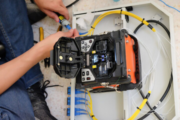 Technicians are cutting and fusion fiber optic cables.