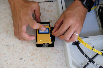 Technicians are cutting and fusion fiber optic cables.