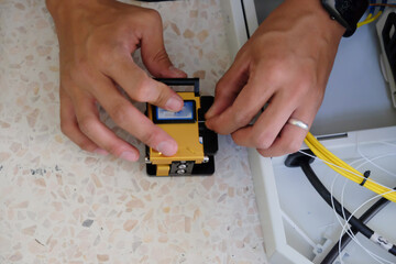 Technicians are cutting and fusion fiber optic cables.