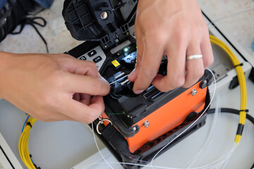 Technicians are cutting and fusion fiber optic cables.