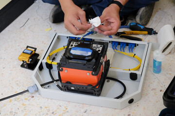 Technicians are cutting and fusion fiber optic cables.