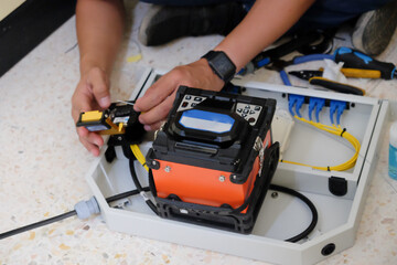 Technicians are cutting and fusion fiber optic cables.