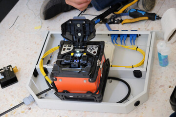 Technicians are cutting and fusion fiber optic cables.