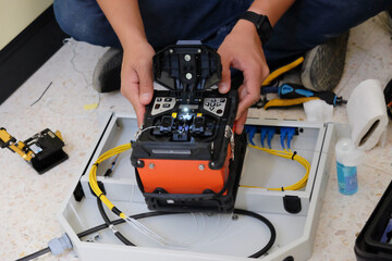 Technicians are cutting and fusion fiber optic cables.