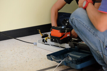 Technicians are cutting and fusion fiber optic cables.
