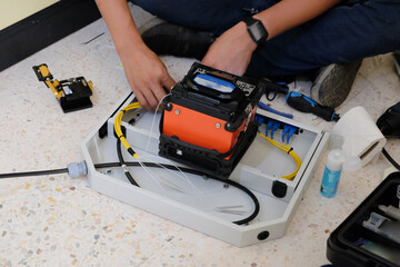 Technicians are cutting and fusion fiber optic cables.