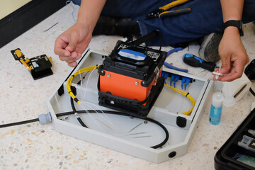 Technicians are cutting and fusion fiber optic cables.
