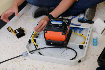 Technicians are cutting and fusion fiber optic cables.