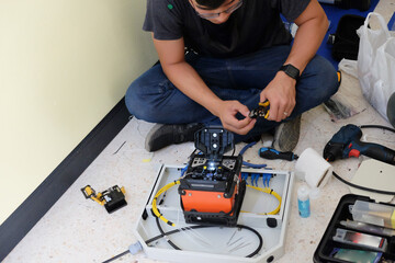 Technicians are cutting and fusion fiber optic cables.