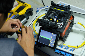 Technicians are cutting and fusion fiber optic cables.