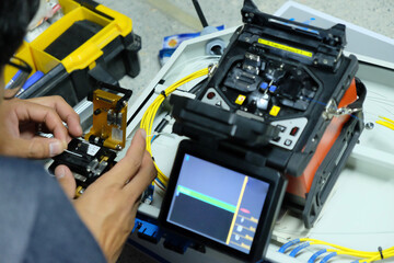 Technicians are cutting and fusion fiber optic cables.