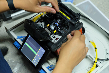 Technicians are cutting and fusion fiber optic cables.