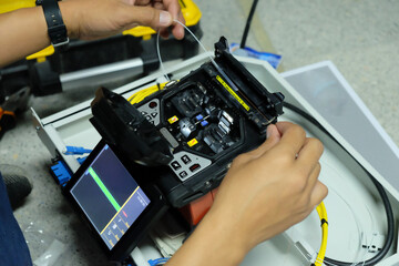 Technicians are cutting and fusion fiber optic cables.