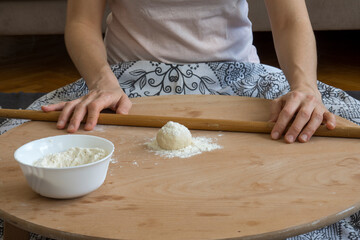 Homemade lahmacun preparation from start to finish. Dough rolls on the floor table