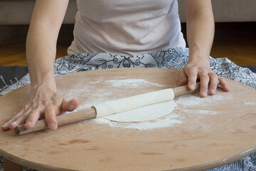 Homemade lahmacun preparation from start to finish. Dough rolls on the floor table