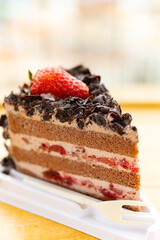 side view chocolate flavor cake with strawberry close up vertical composition