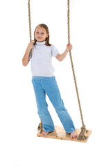 Preteen girl having fun on rope swing