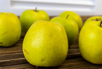 Green apples on wooden background