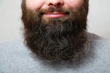Portrait. The man with the thick beard smiles.