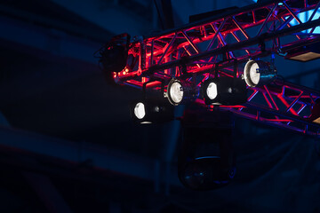 The ceiling of the theatrical scene with multi-colored lighting equipment. Stage lighting.White...